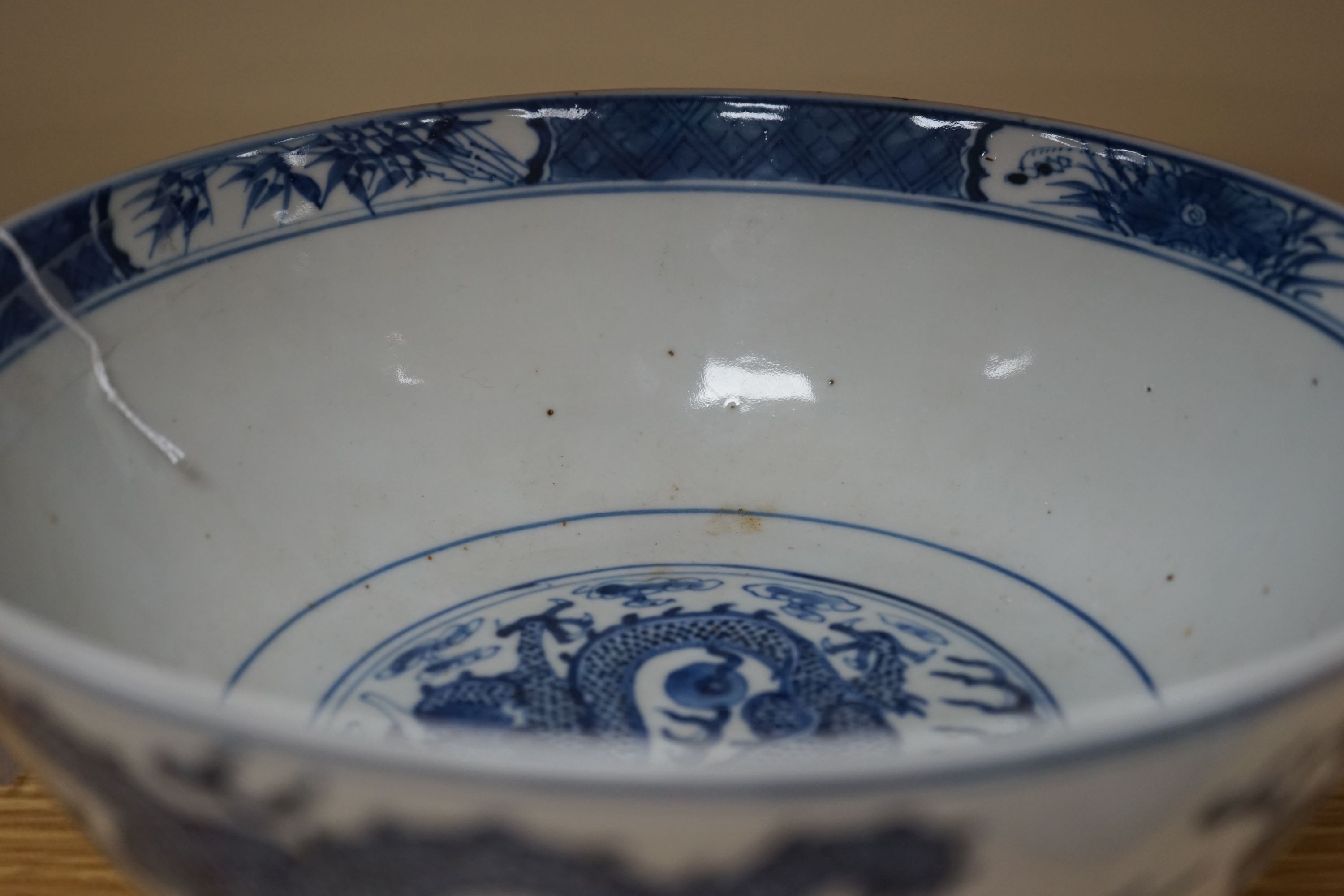 A Chinese blue and white ‘dragon’ bowl, Kangxi mark, late 19th century 25cm